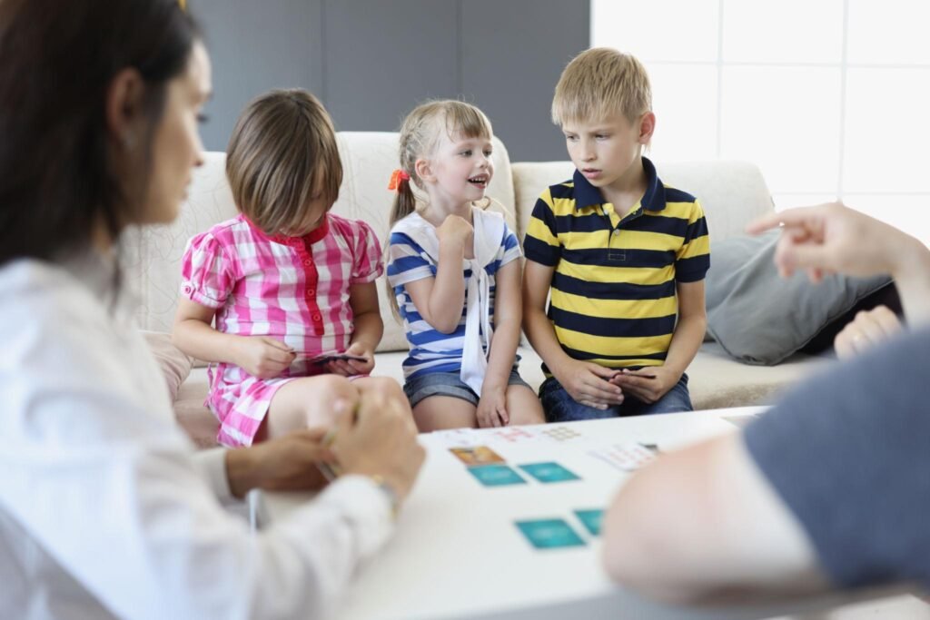 Kids playing Happy Families card game with happy and grouchy expressions