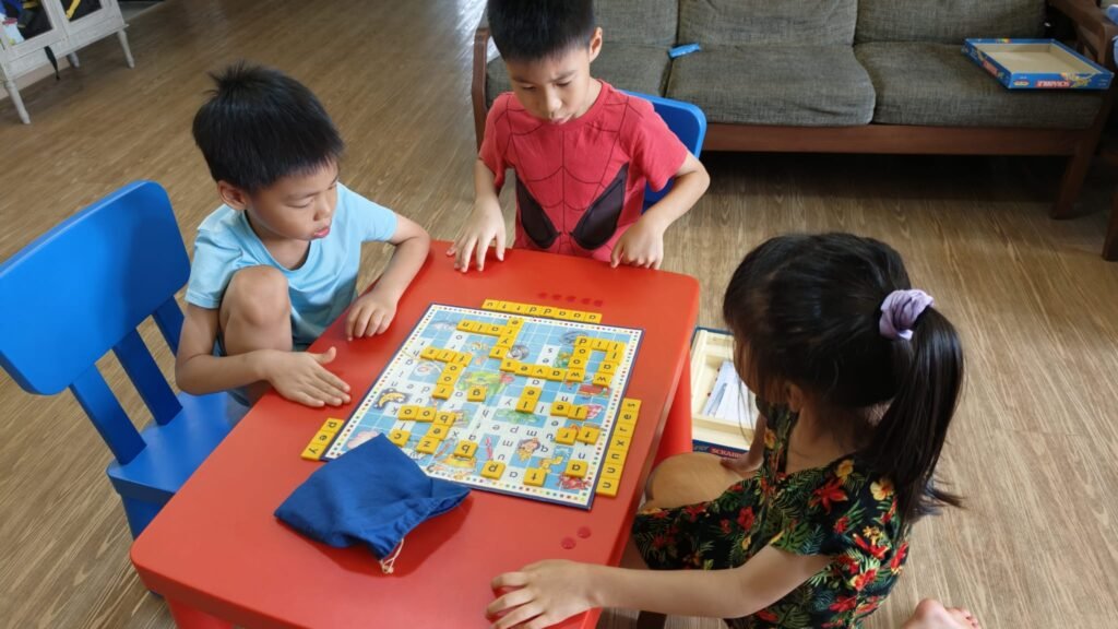 Three kids playing Junior Scrabble together at home