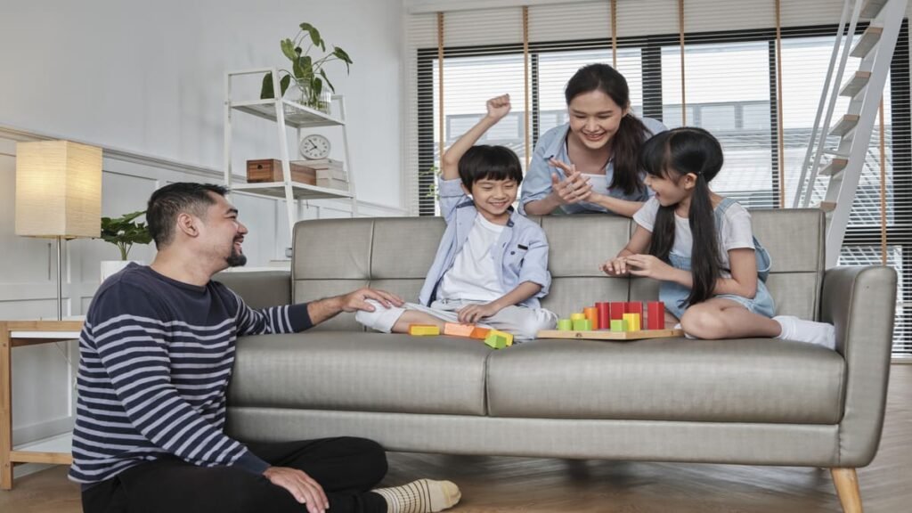 Family playing a cooperative board game together on the sofa