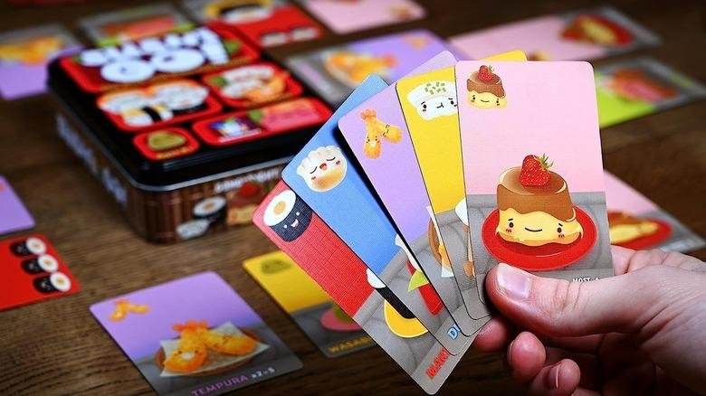 Sushi Go card game showing cute sushi cards including pudding and nigiri