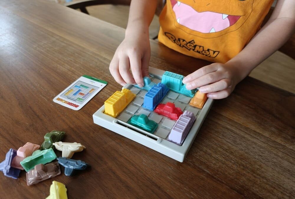 Child solving a Rush Hour traffic jam puzzle game independently