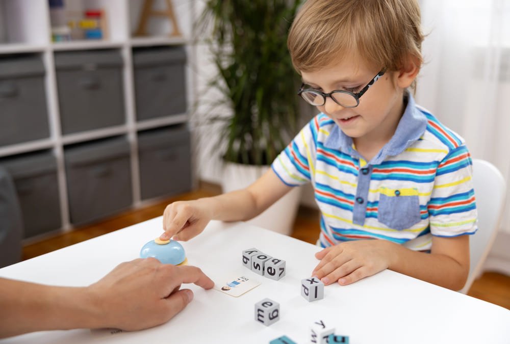 A young boy concentrating on his game during his turn