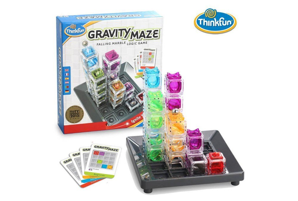 Gravity Maze’s transparent coloured towers on a black grid beside challenge cards and the game box
